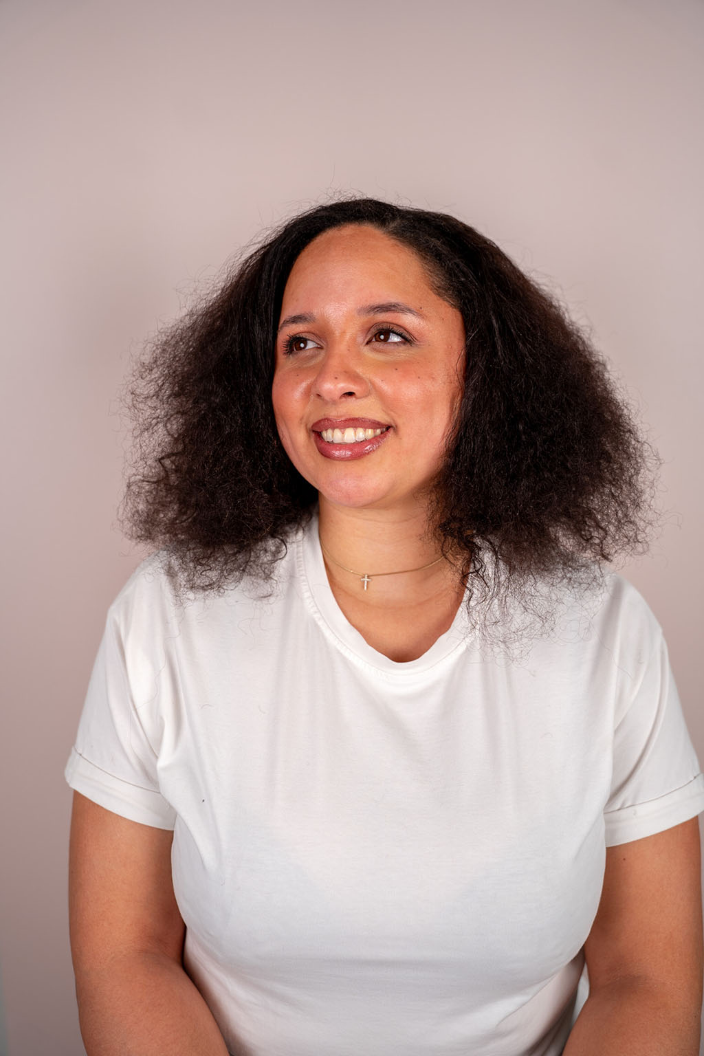 Woman wearing a white t-shirt against a plain background